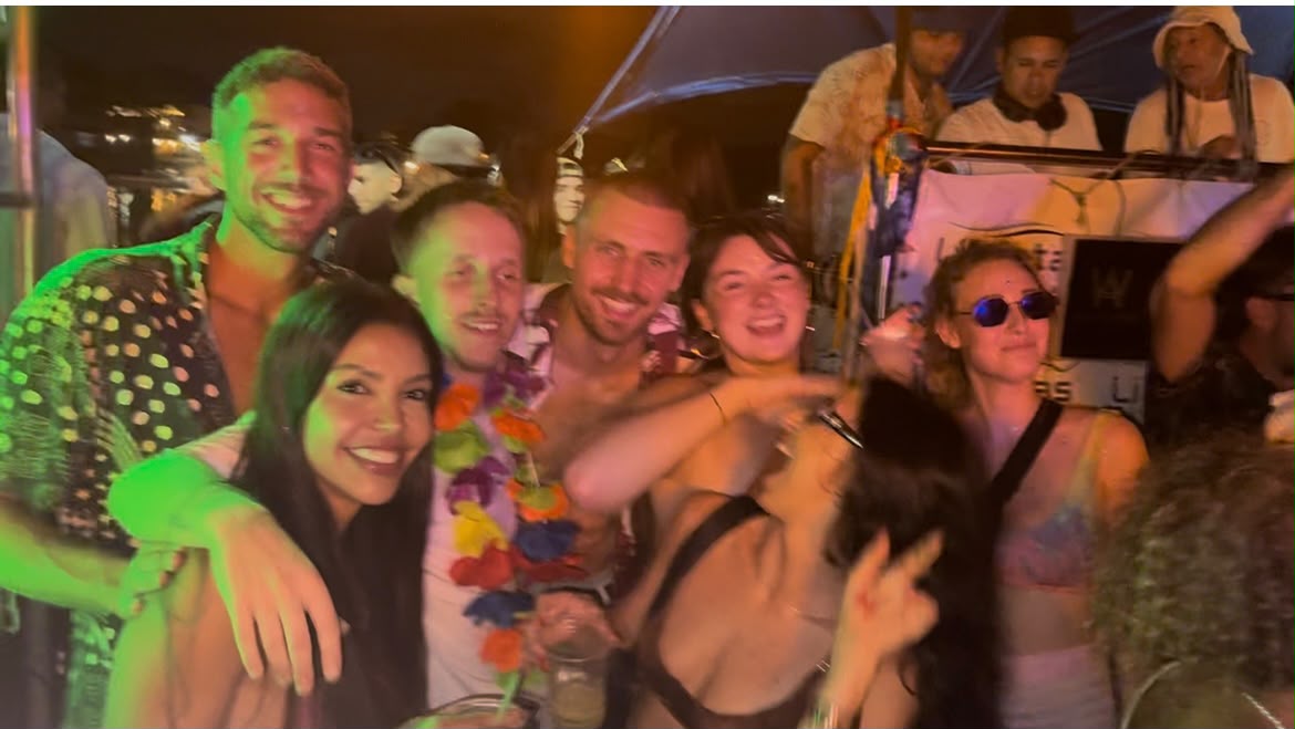 The group packed together dancing at a night boat party in Búzios